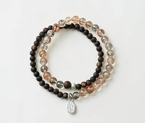 Black Super Seven bracelet with Agarwood beads, handmade crystal jewelry on white background